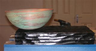 Mark's bowl displayed on a black stand